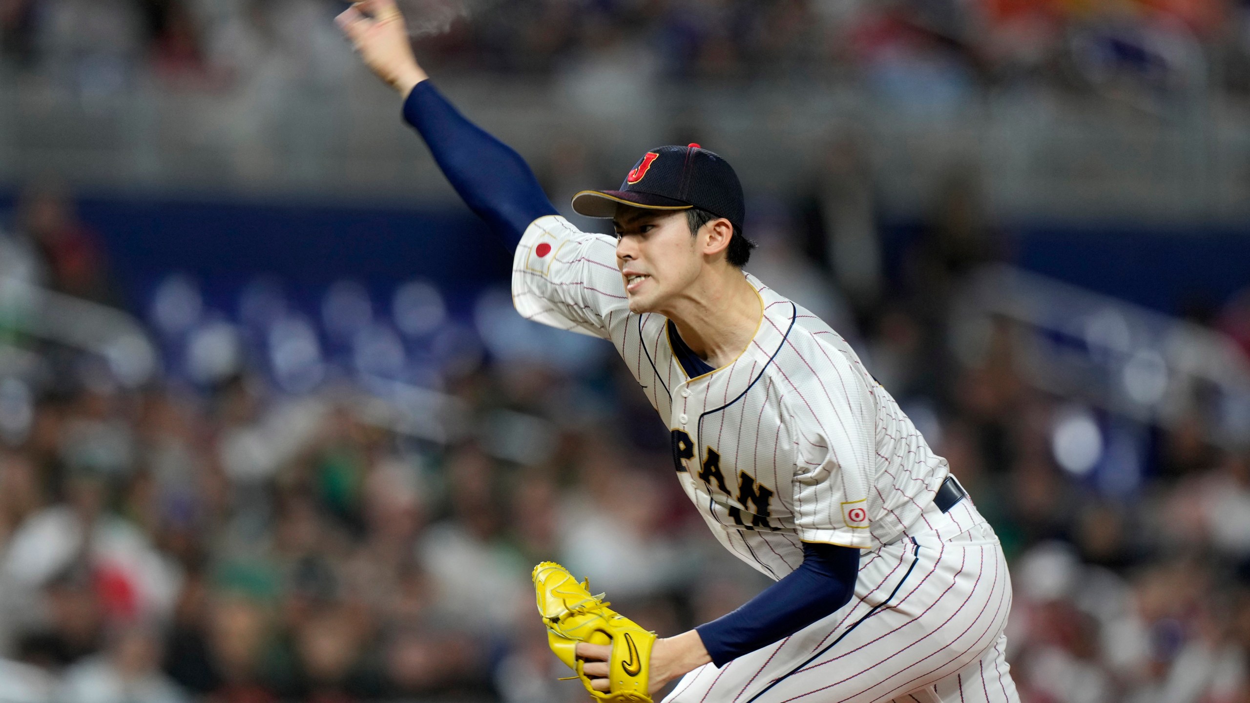 FILE- Japan's Roki Sasaki delivers a pitch during the first inning of a World Baseball Classic game against Mexico, Monday, March 20, 2023, in Miami. (AP Photo/Wilfredo Lee, File)