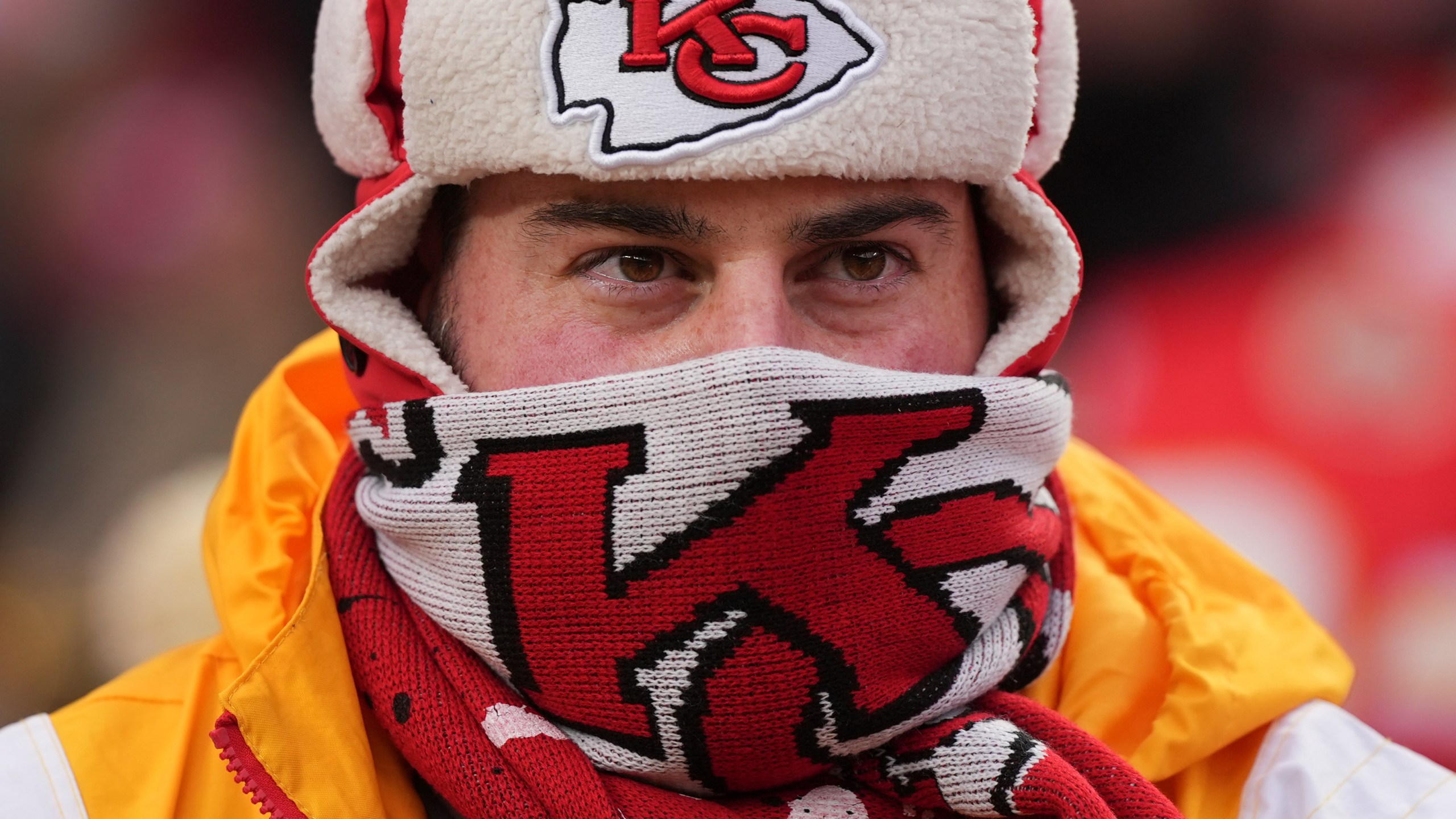 A person is bundled up for the cold during the first half of an NFL football AFC divisional playoff game between the Kansas City Chiefs and the Houston Texans Saturday, Jan. 18, 2025, in Kansas City, Mo. (AP Photo/Charlie Riedel)