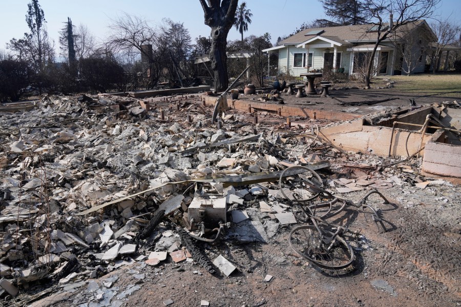 Debris from a destroyed home is seen as a newly built ADU (accessory dwelling unit) stands behind after surviving the Eaton Fire, Sunday, Jan. 19, 2025, in Altadena, Calif. (AP Photo/Damian Dovarganes)