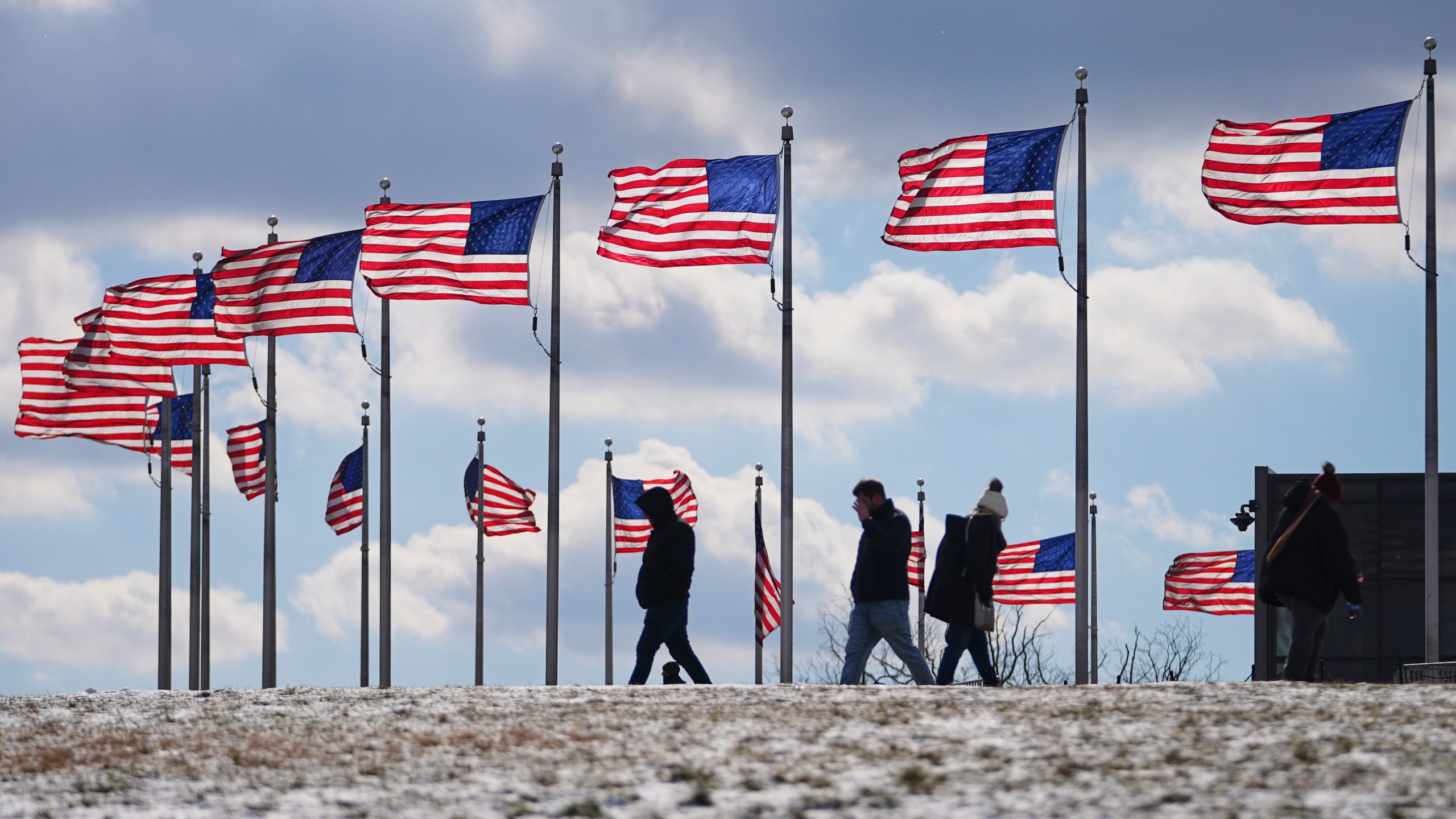 U.S. flags around the Washington Monument are at full staff during the 60th Presidential Inauguration, Monday, Jan. 20, 2025, in Washington. Flags are supposed to fly at half-staff through the end of January out of respect for former President Jimmy Carter, who died Dec. 29, 2024. (AP Photo/Julio Cortez)