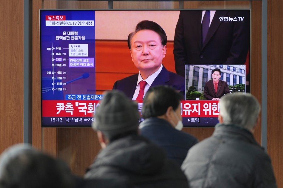 A TV screen shows footage of impeached South Korean President Yoon Suk Yeol during a news program at the Seoul Railway Station in Seoul, South Korea, Tuesday, Jan. 21, 2025. (AP Photo/Lee Jin-man)
