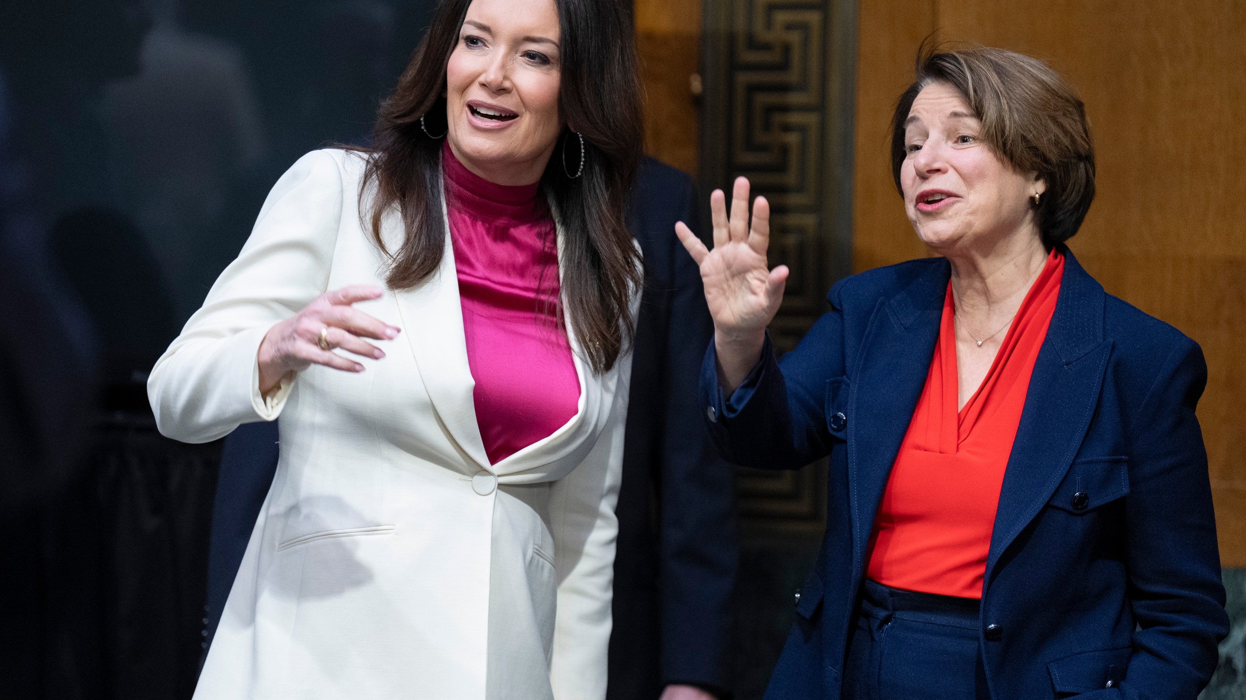 Brooke Rollins, left, and Senate Agriculture, Nutrition, and Forestry Committee Ranking Member Sen. Amy Klobuchar, D-Minn., greet people ahead of a committee hearing on Rollins' nomination for Secretary of Agriculture, Thursday, Jan. 23, 2025, in Washington. (AP Photo/Jacquelyn Martin)
