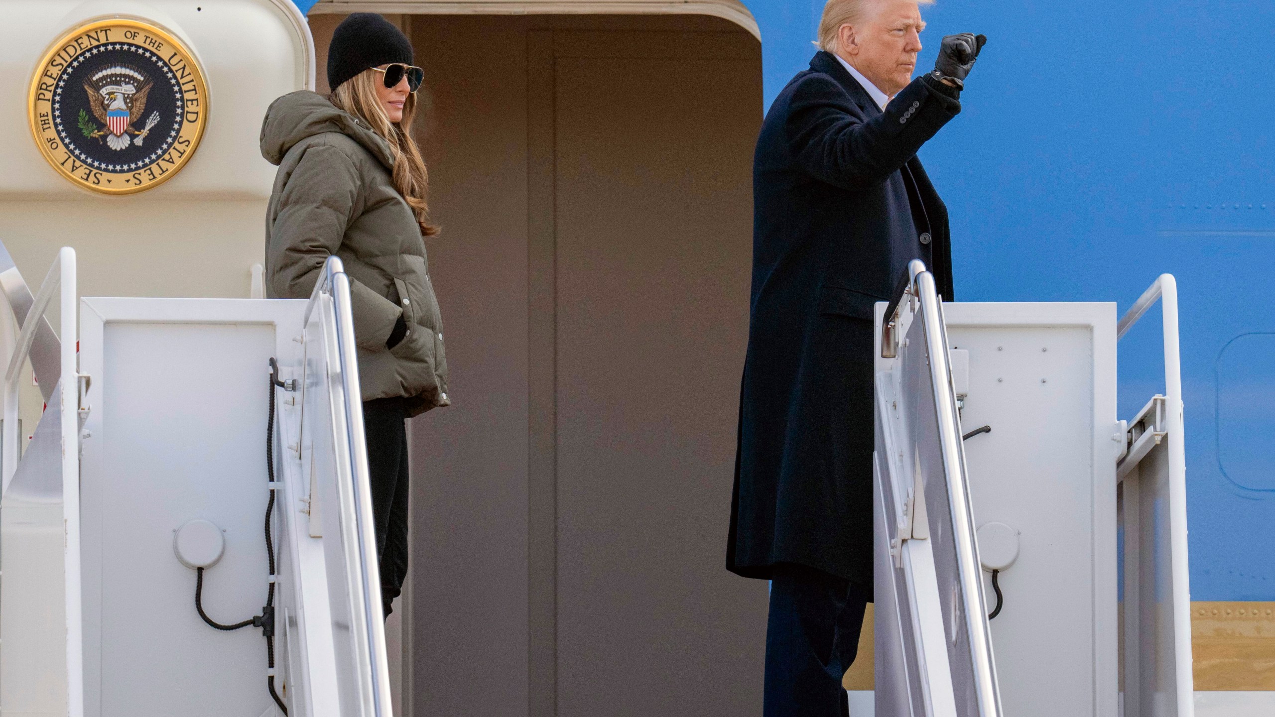 President Donald Trump and first lady Melania Trump wave as they board Air Force One at Joint Base Andrews, Md., Friday, Jan. 24, 2025, en route to Asheville, N.C. (AP Photo/Jess Rapfogel)