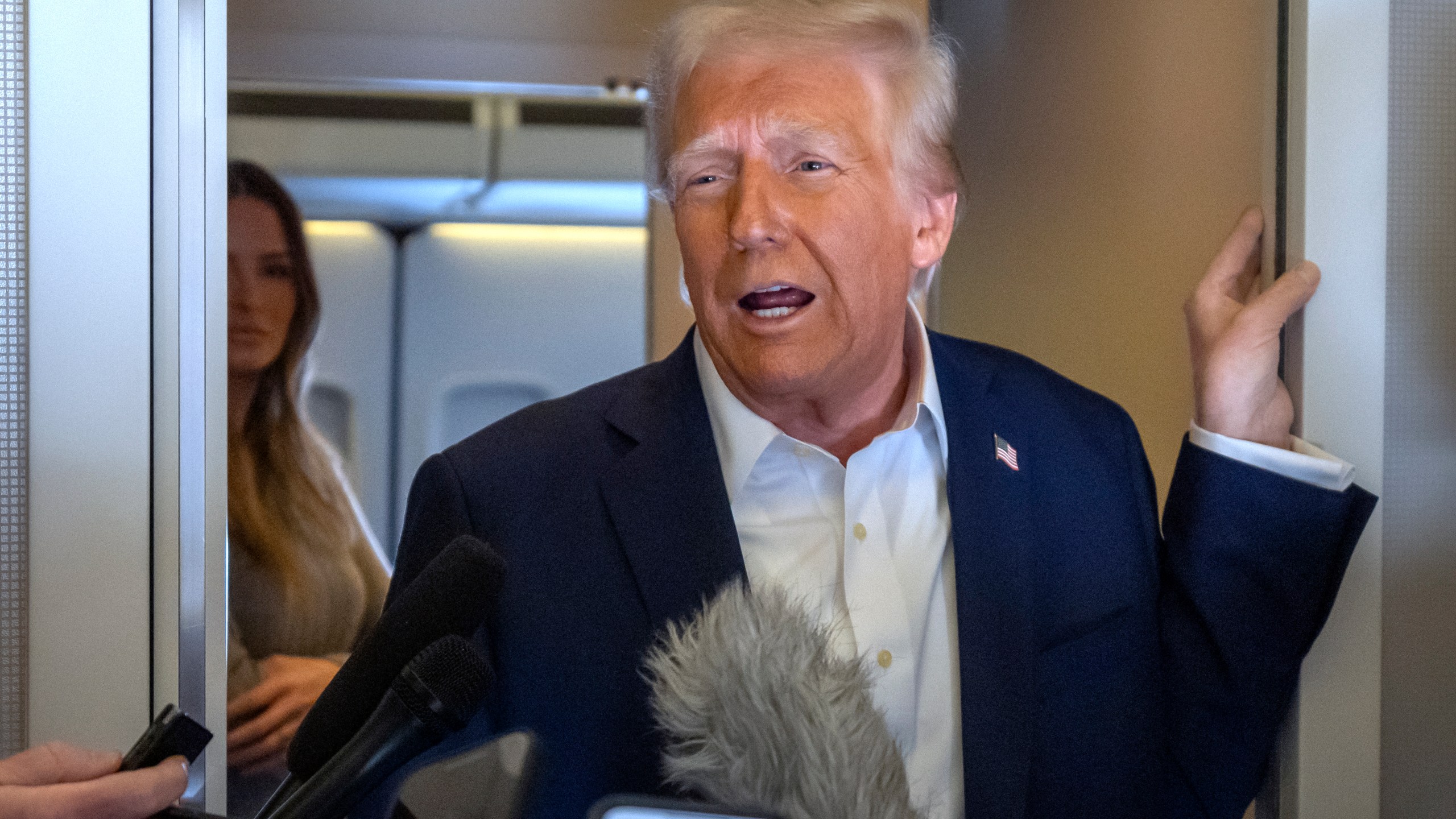 President Donald Trump speaks to reporters aboard Air Force One as he travels from Las Vegas to Miami on Saturday, Jan. 25, 2025. (AP Photo/Mark Schiefelbein)