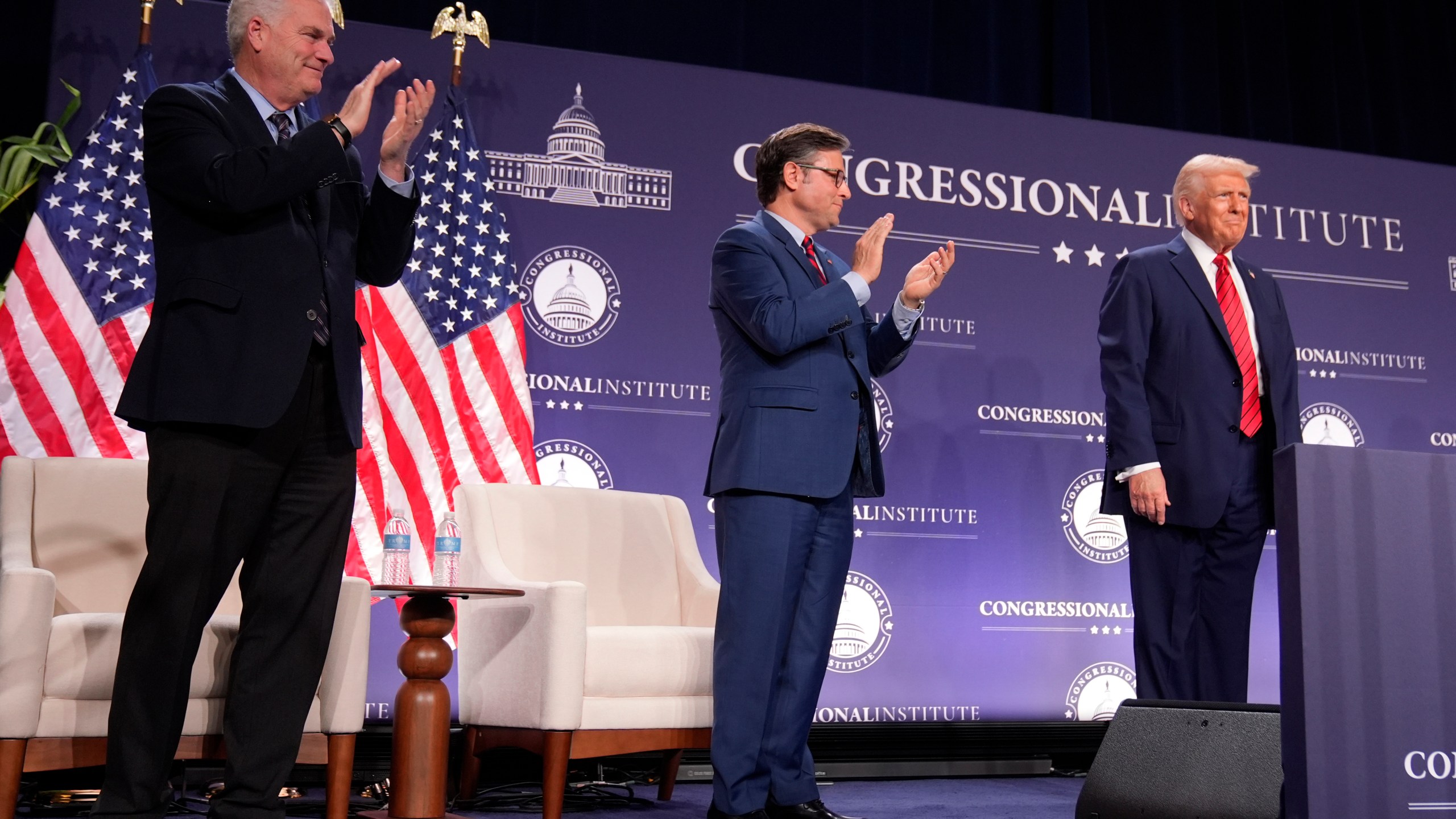 Rep. Tom Emmer, R-Minn., left, and House Speaker Mike Johnson of La., applaud President Donald Trump at the 2025 House Republican Members Conference Dinner at Trump National Doral Miami in Doral, Fla., Monday, Jan. 27, 2025. (AP Photo/Mark Schiefelbein)
