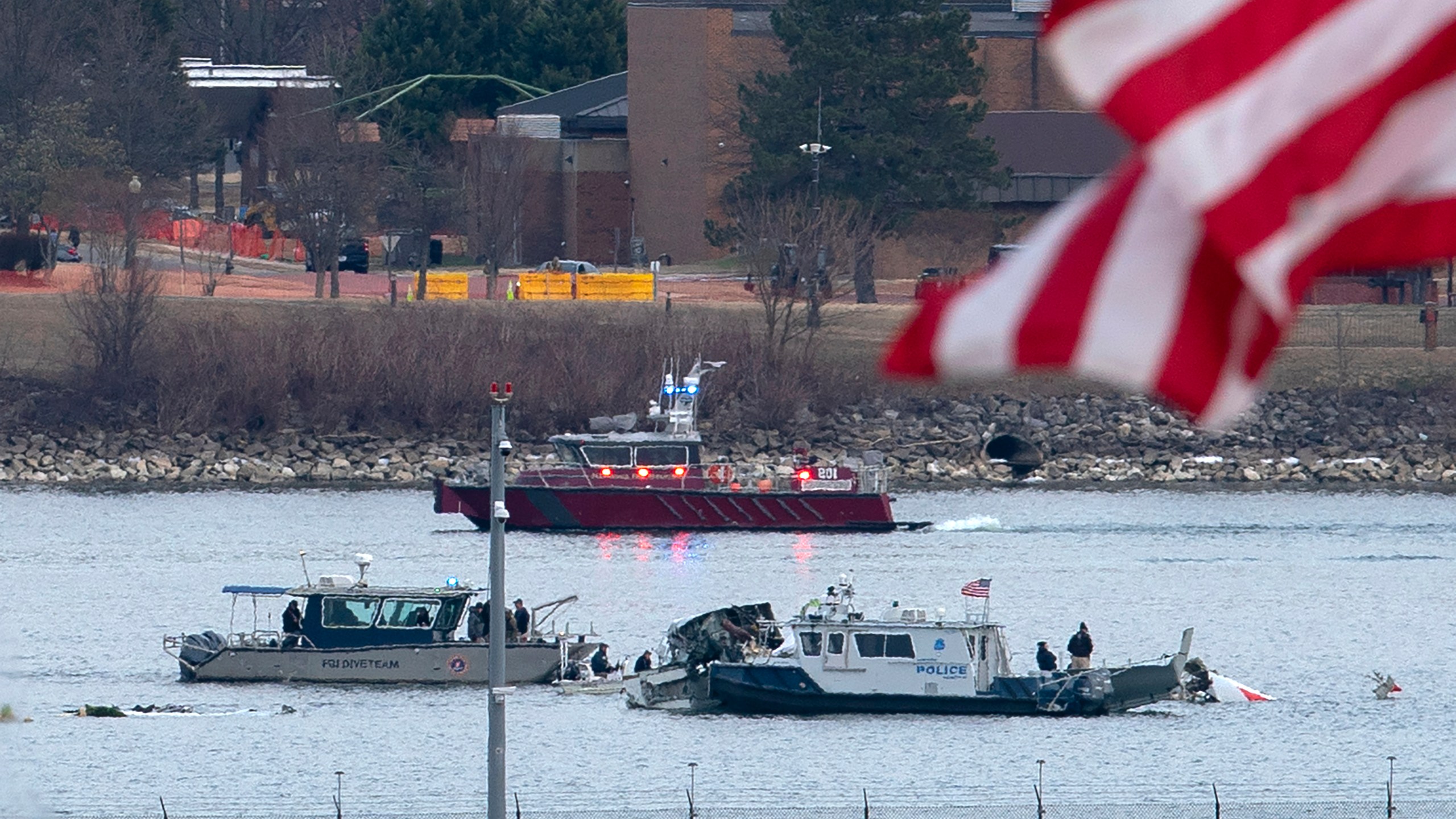 A diving team and police boat is seen around a wreckage site in the Potomac River from Ronald Reagan Washington National Airport, Thursday, Jan. 30, 2025, in Arlington, Va. (AP Photo/Jose Luis Magana)