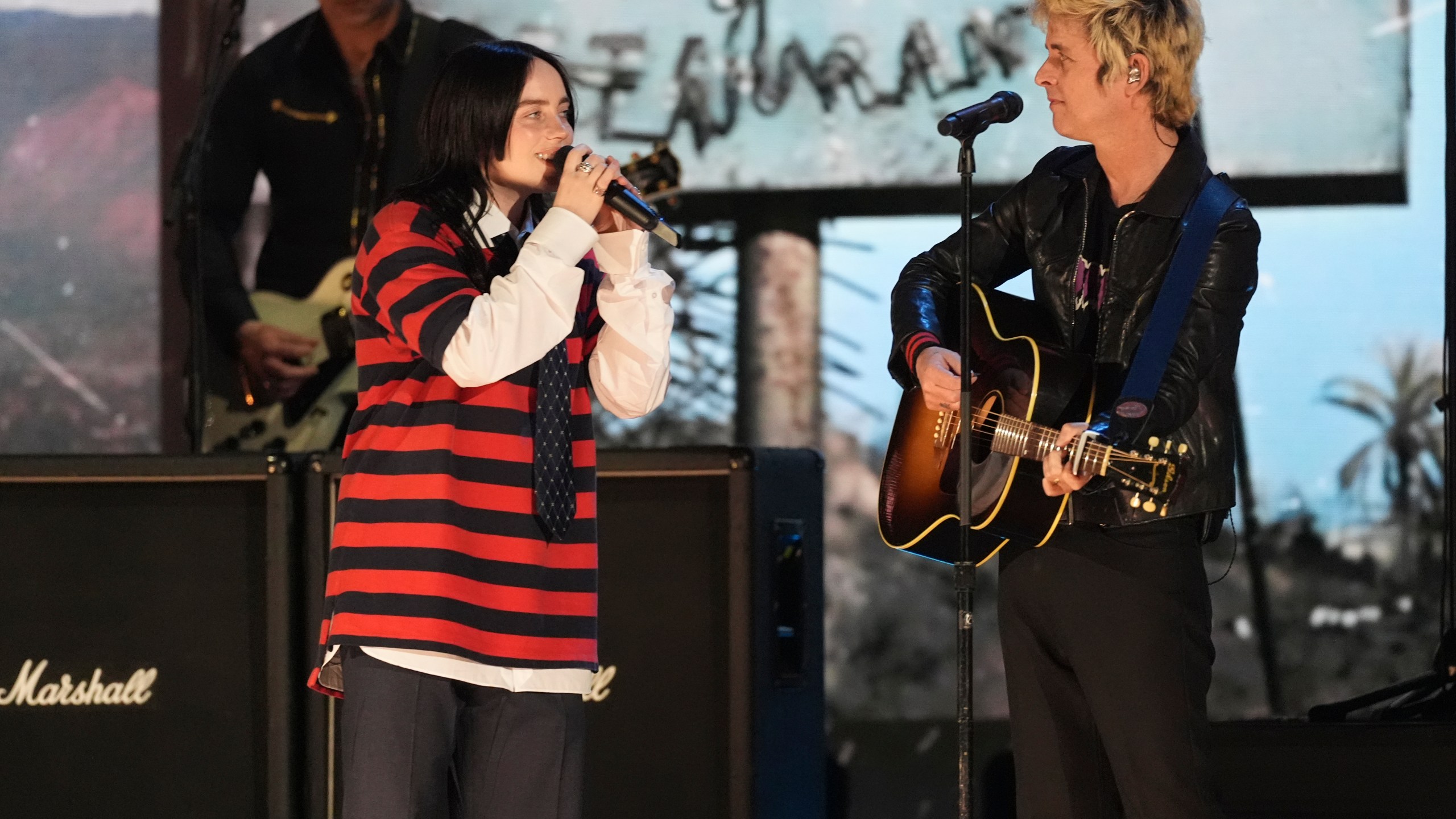 Billie Eilish, left, performs with Billie Joe Armstrong of Green Day during the FireAid benefit concert on Thursday, Jan. 30, 2025, at The Forum in Inglewood, Calif. (AP Photo/Chris Pizzello)