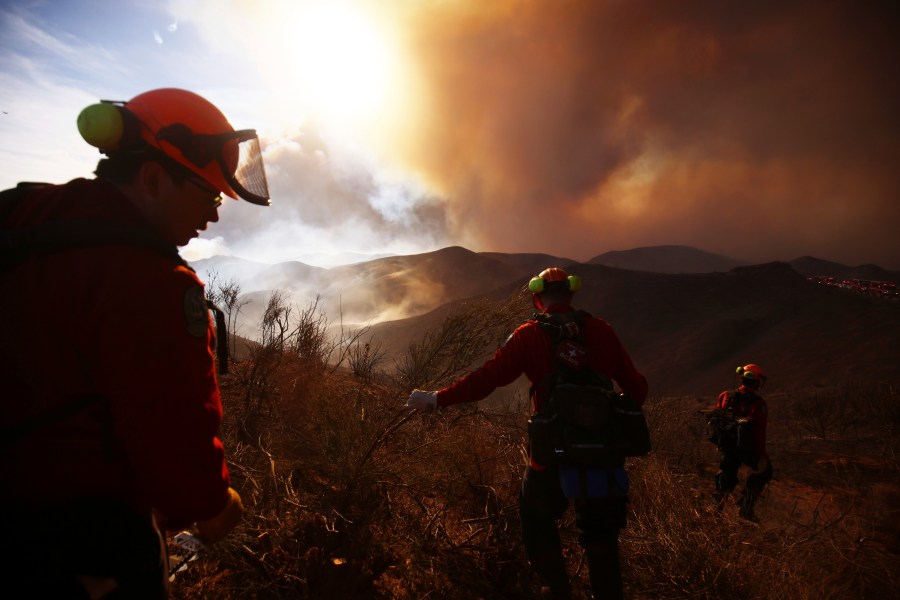 Firefighters work to control the spread of the Hughes Fire in Castaic, Calif., Wednesday, Jan. 22, 2025. (AP Photo/Ethan Swope)