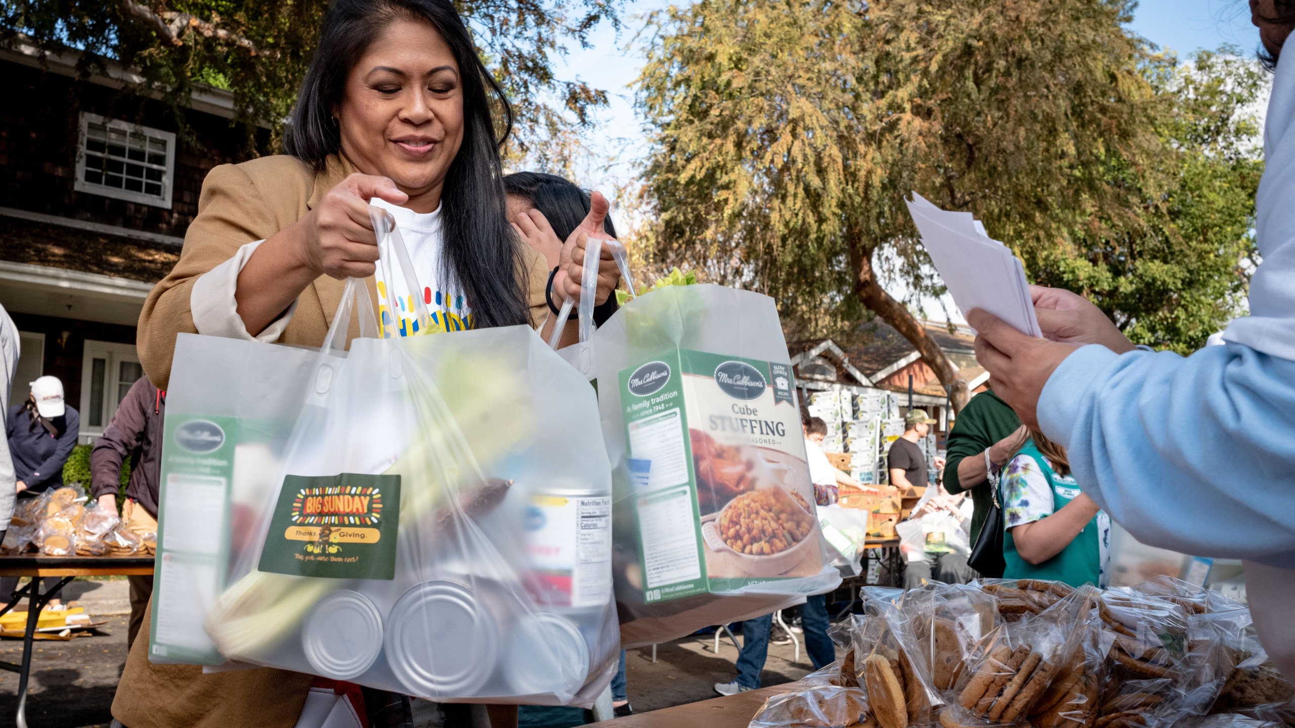 Volunteers collect bags of food to be distributed by local organizations in Studio City, California. (Photo by David Crane/MediaNews Group/Los Angeles Daily News via Getty Images)