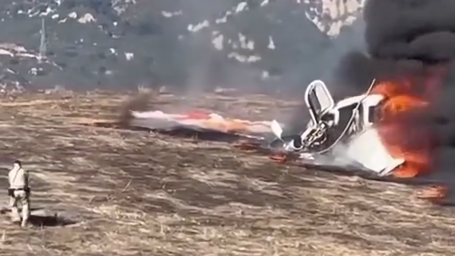 A California Highway Patrol officer pulls the pilot from a fiery plane crash in Goleta on Jan. 29, 2025. (Steve Epstein via CHP)