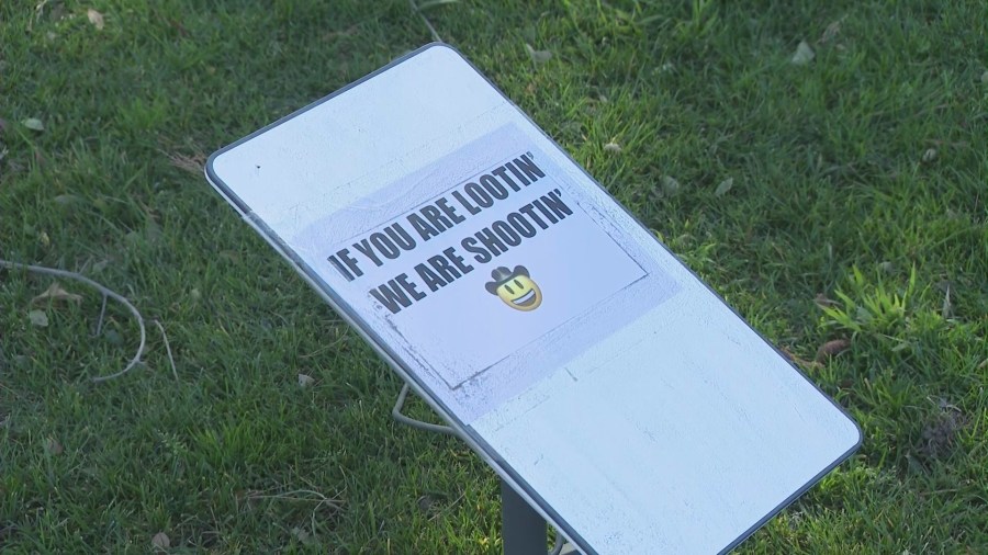 A sign posted on EveAnna Manley's front lawn alerting potential trespassers that she is armed. (KTLA)