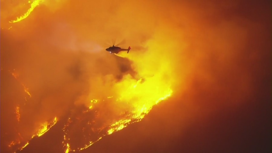Aerial crews drop water on a brush fire near the Sepulveda Pass on Jan. 22, 2025. (KTLA)