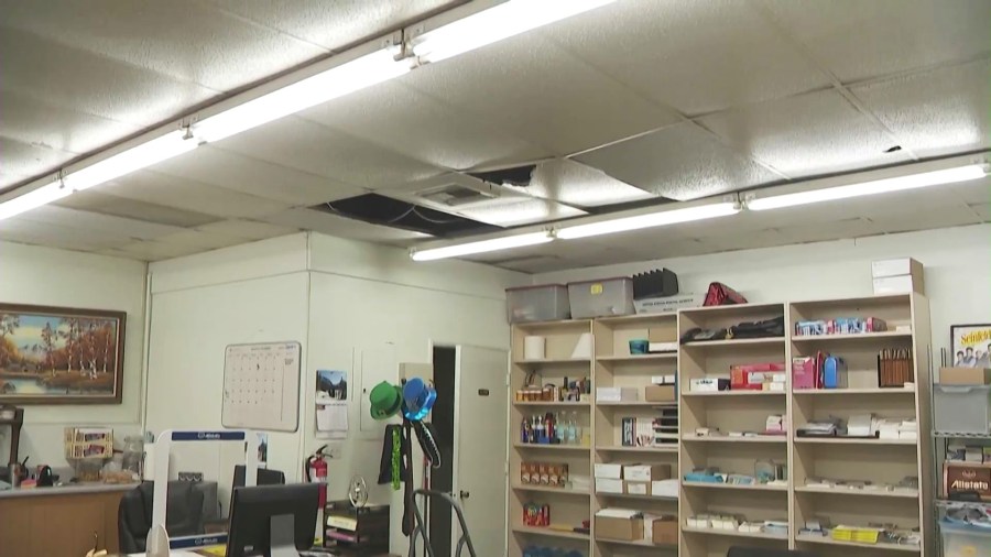 Ceiling panels were destroyed after the suspect climbed through the roof and into the victim's office in Fontana. (KTLA)