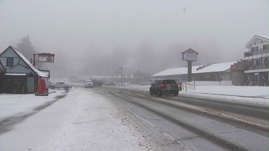 A main road is covered in snow in Running Springs, a community in the San Bernardino mountains. (KTLA)