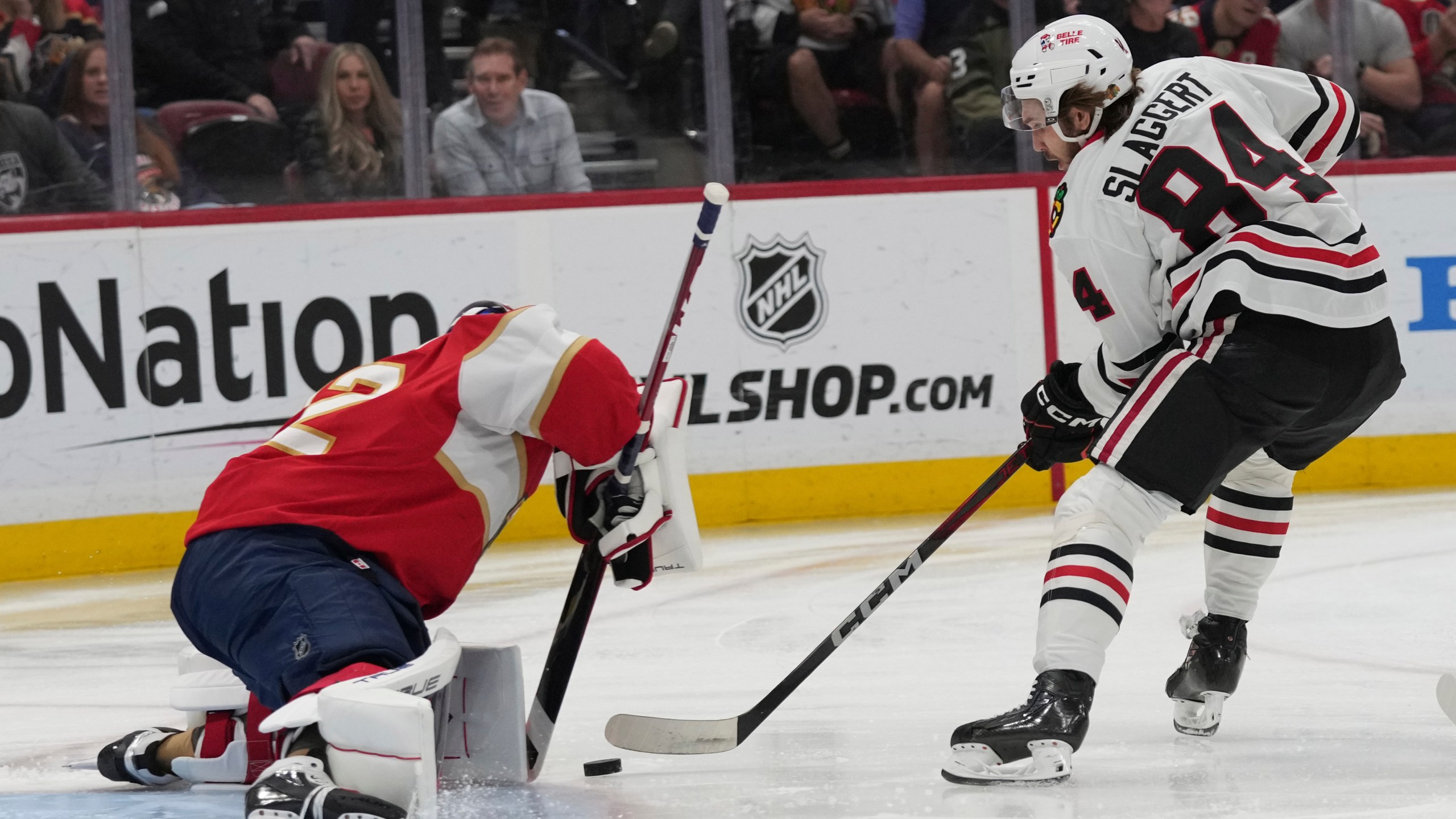Chicago Blackhawks left wing Landon Slaggert (84) scores a goal against Florida Panthers goaltender Sergei Bobrovsky (72) during the first period of an NHL hockey game, Saturday, Feb. 1, 2025, in Sunrise, Fla. (AP Photo/Lynne Sladky)