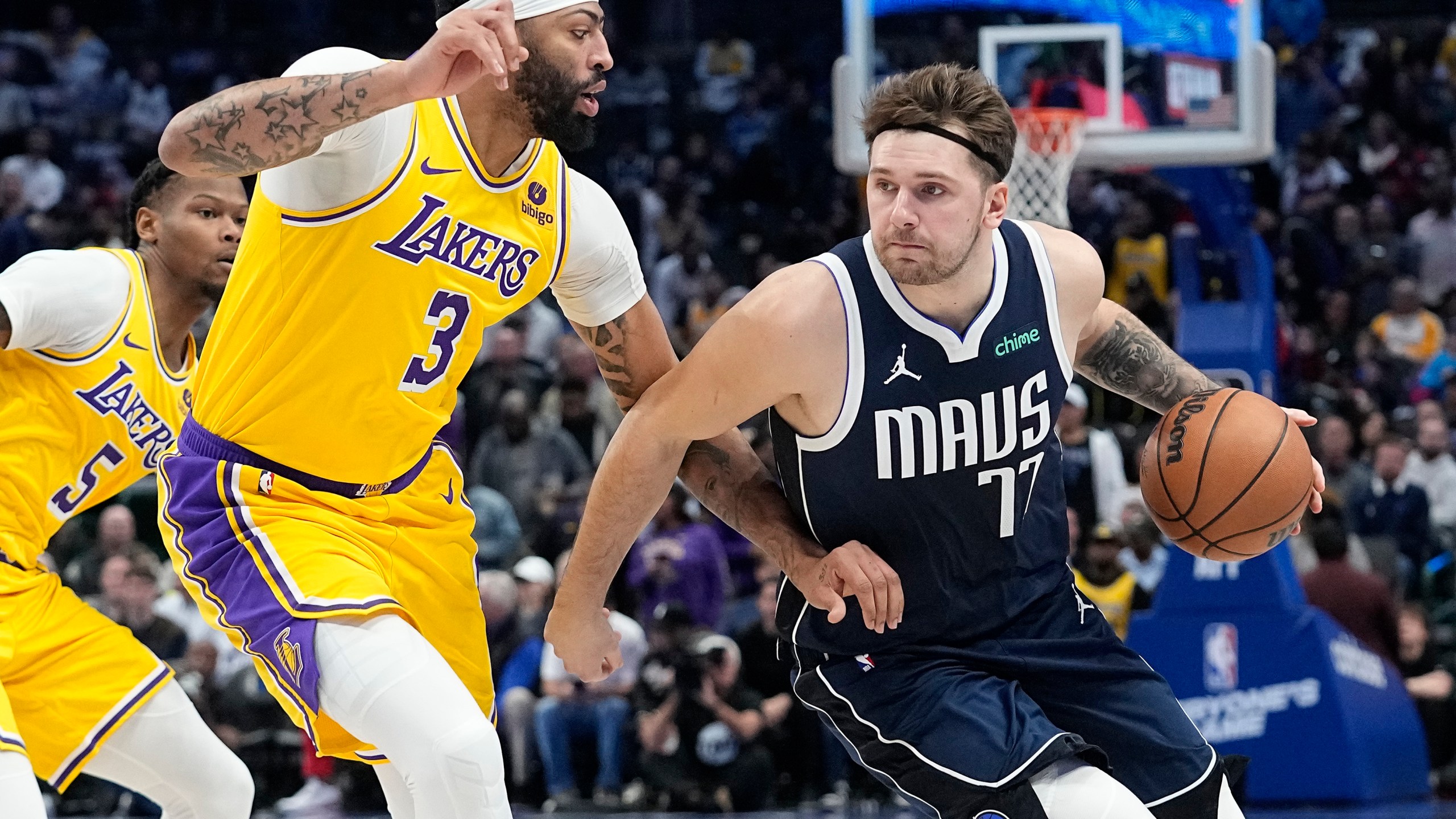FILE - Dallas Mavericks guard Luka Doncic drives against Los Angeles Lakers forward Anthony Davis (3) during the first half of an NBA basketball game in Dallas, Tuesday, Dec. 12, 2023. (AP Photo/LM Otero, File)
