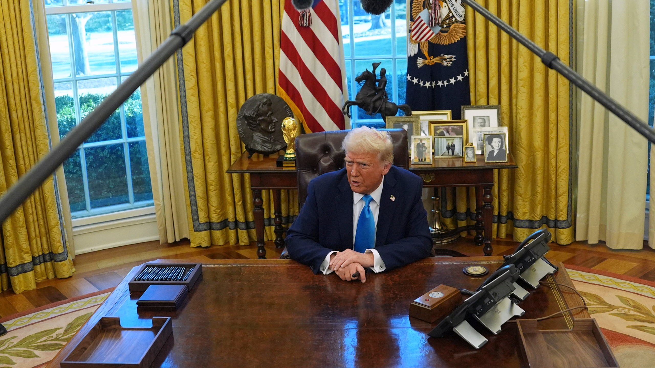 President Donald Trump speaks to reporters as he signs executive orders in the Oval Office of the White House, Tuesday, Feb. 4, 2025, in Washington. (AP Photo/Evan Vucci)