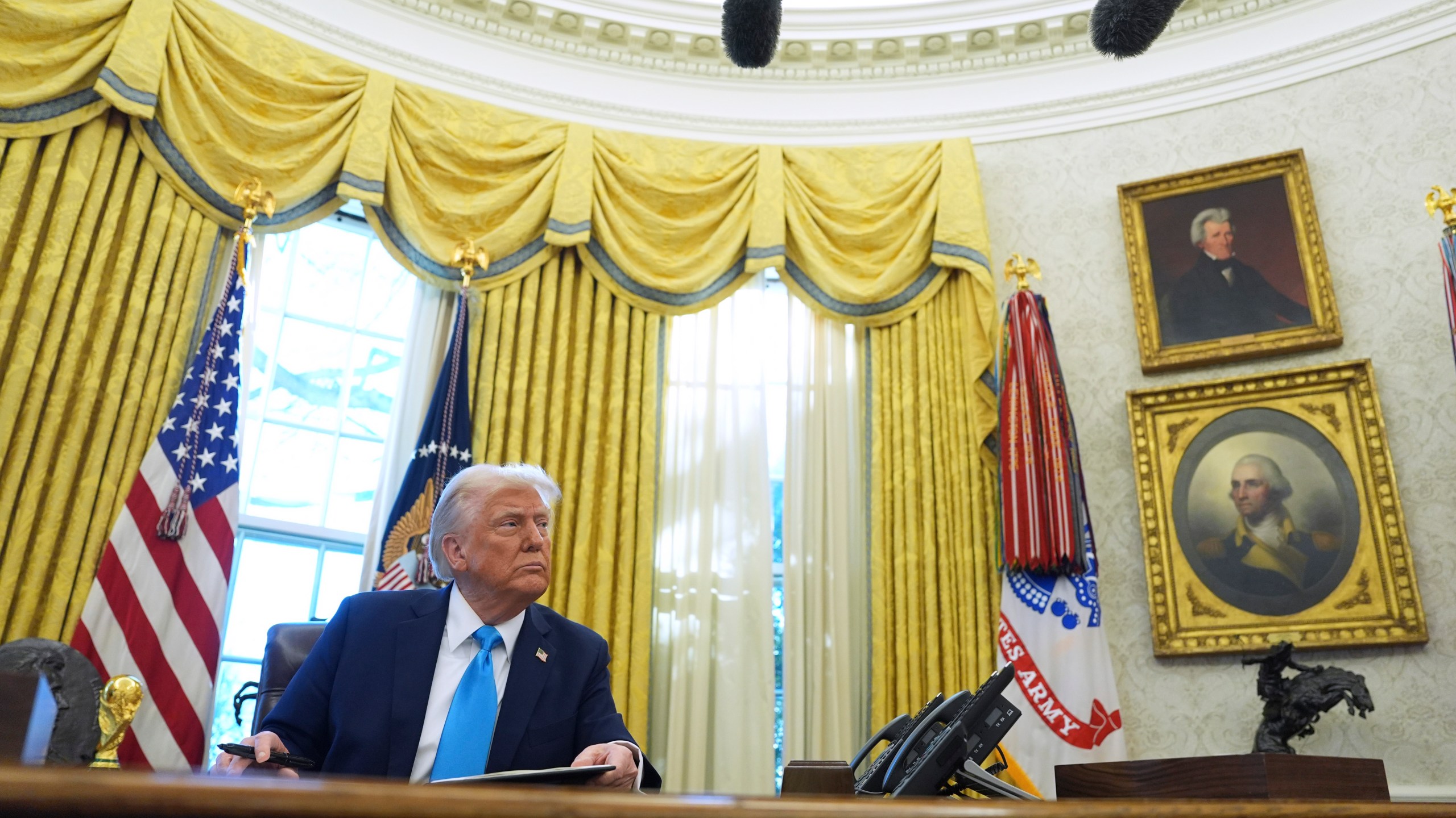 President Donald Trump speaks to reporters as he signs executive orders in the Oval Office of the White House, Tuesday, Feb. 4, 2025, in Washington. (AP Photo/Evan Vucci)