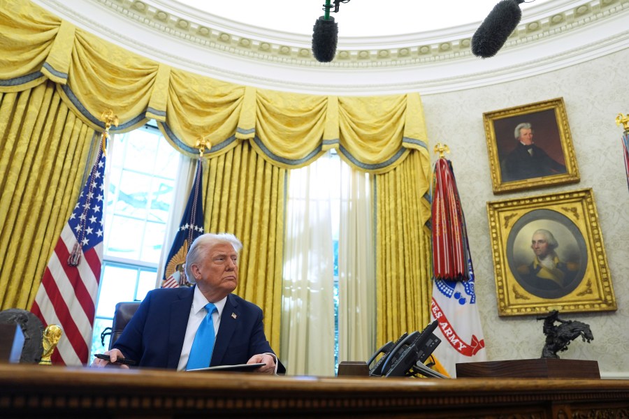 President Donald Trump speaks to reporters as he signs executive orders in the Oval Office of the White House, Tuesday, Feb. 4, 2025, in Washington. (AP Photo/Evan Vucci)