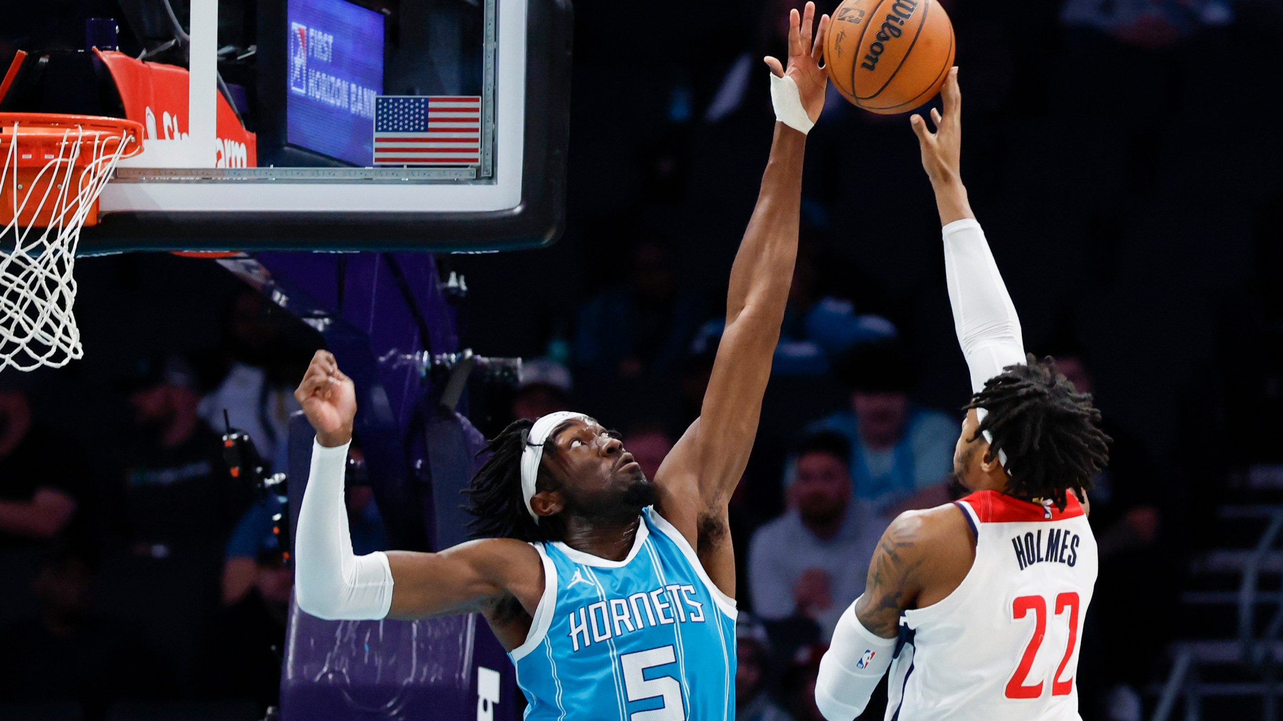 Charlotte Hornets center Mark Williams (5) blocks a shot by Washington Wizards forward Richaun Holmes (22) during the first half of an NBA basketball game in Charlotte, N.C., Monday, Feb. 3, 2025. (AP Photo/Nell Redmond)