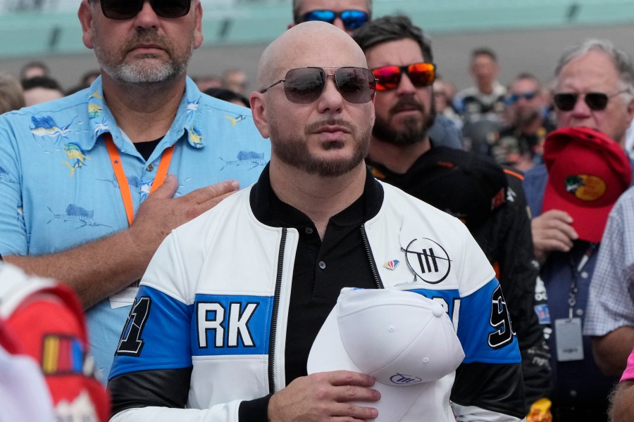 FILE - Singer, songwriter Pitbull stands during the singing of the national anthem before the start of the NASCAR Cup Series auto race at Homestead-Miami Speedway, Sunday, Oct. 22, 2023 in Homestead, Fla. (AP Photo/Wilfredo Lee, File)