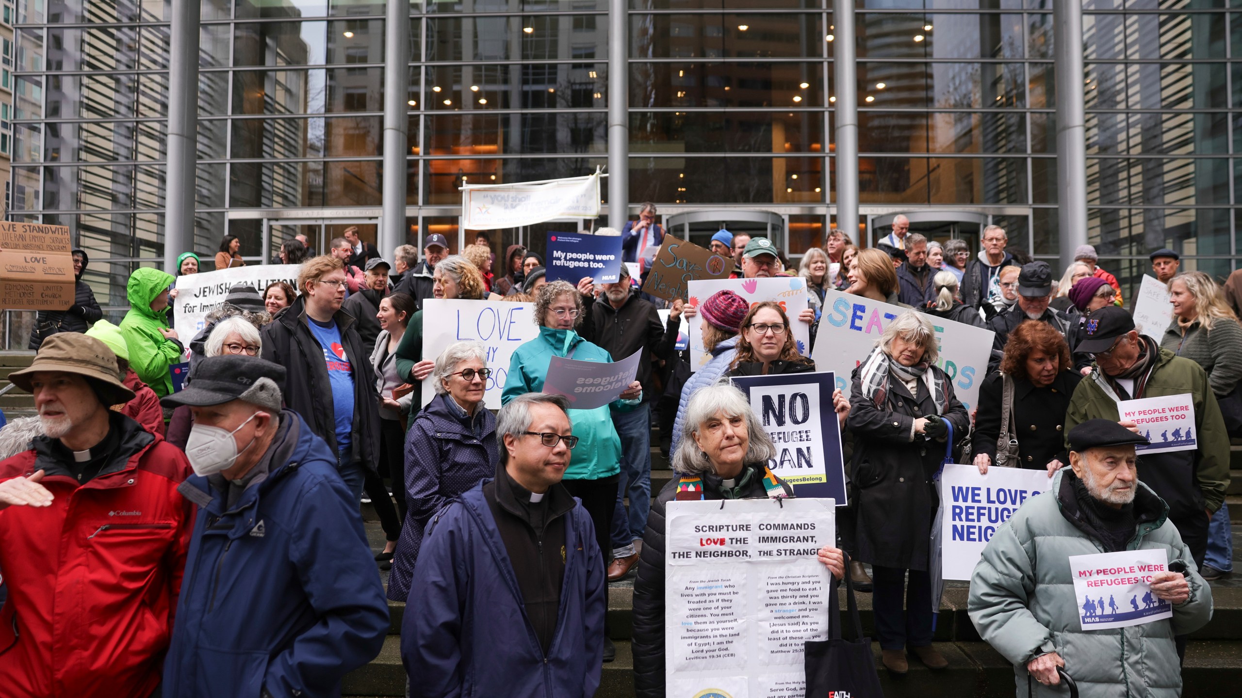 People gather outside the U.S. District Court after a federal judge blocked President Donald Trump's effort to halt the nation's refugee admissions system Tuesday, Feb. 25, 2025, in Seattle. (AP Photo/Ryan Sun)