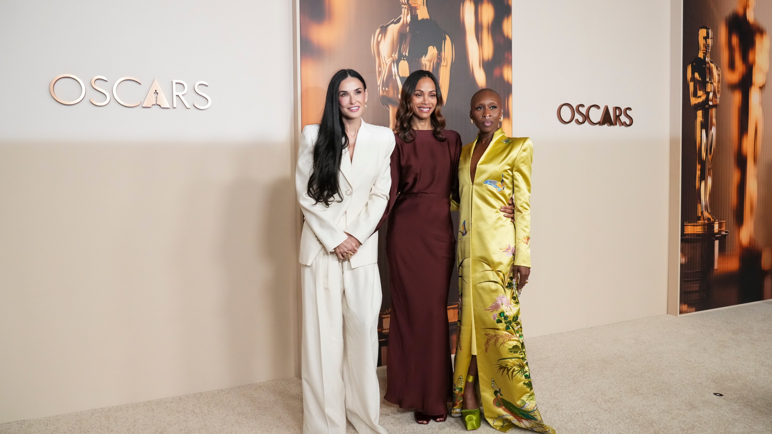 Demi Moore, from left, Zoe Saldana, and Cynthia Erivo arrive at the Oscars Nominees Dinner on Tuesday, Feb. 25, 2025, at the Academy Museum of Motion Pictures in Los Angeles. (Photo by Jordan Strauss/Invision/AP)