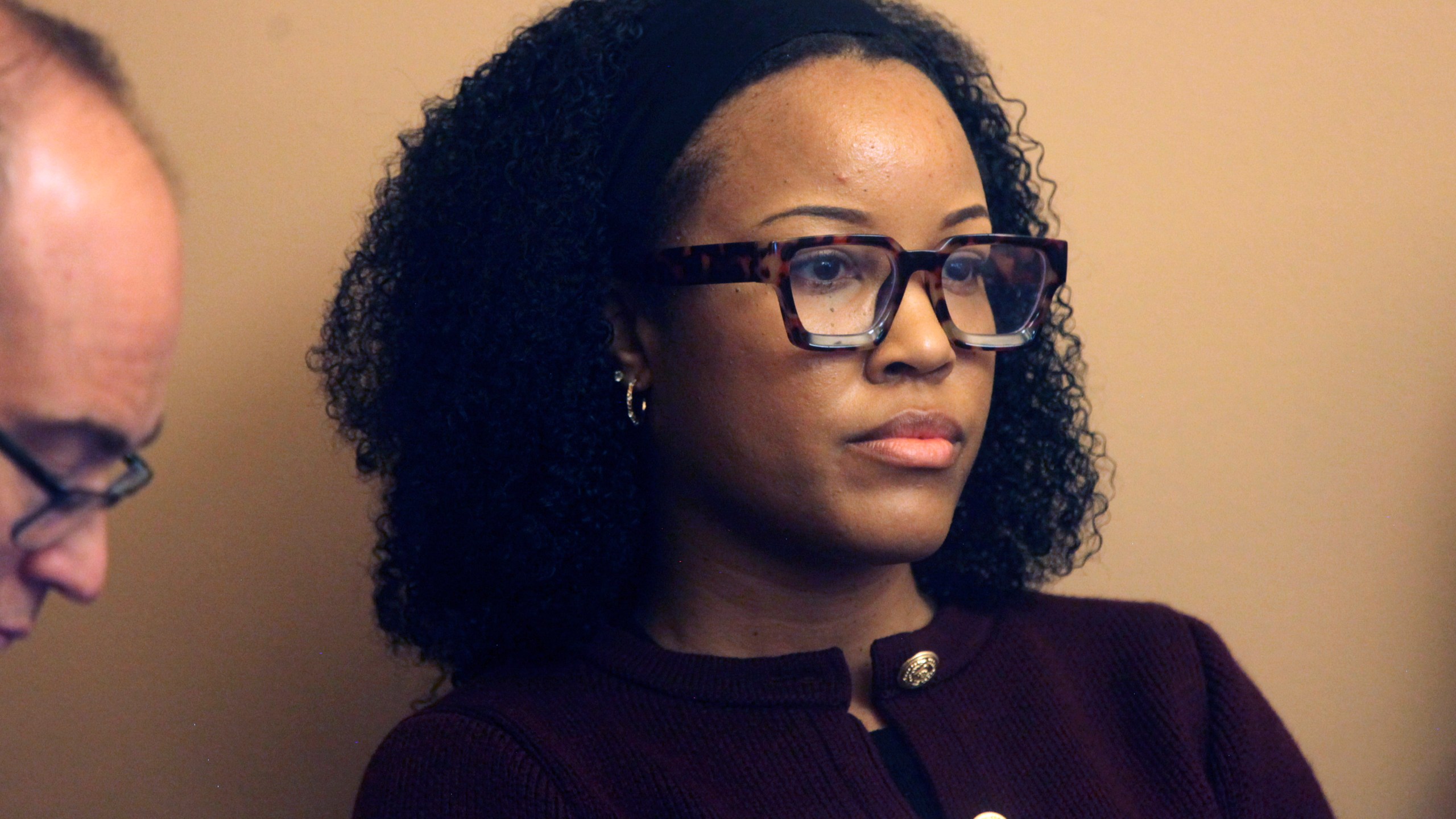 Rashane Hamby, policy director for the American Civil Liberties Union of Kansas, follows testimony in a legislative committee hearing on a proposal her group opposes to have state Supreme Court justices elected rather than appointed by the governor after applicants are screened by a nominating commission, Tuesday, Feb. 25, 2025, at the Statehouse in Topeka, Kans. (AP Photo/John Hanna)