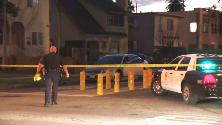 Police investigate a silver sedan with bullet holes after three people, including an infant, were hospitalized in a drive-by shooting in South L.A. on Feb. 8, 2025. (KTLA)