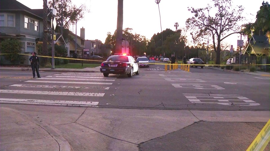 Police investigate a silver sedan with bullet holes after three people, including an infant, were hospitalized in a drive-by shooting in South L.A. on Feb. 8, 2025. (KTLA)