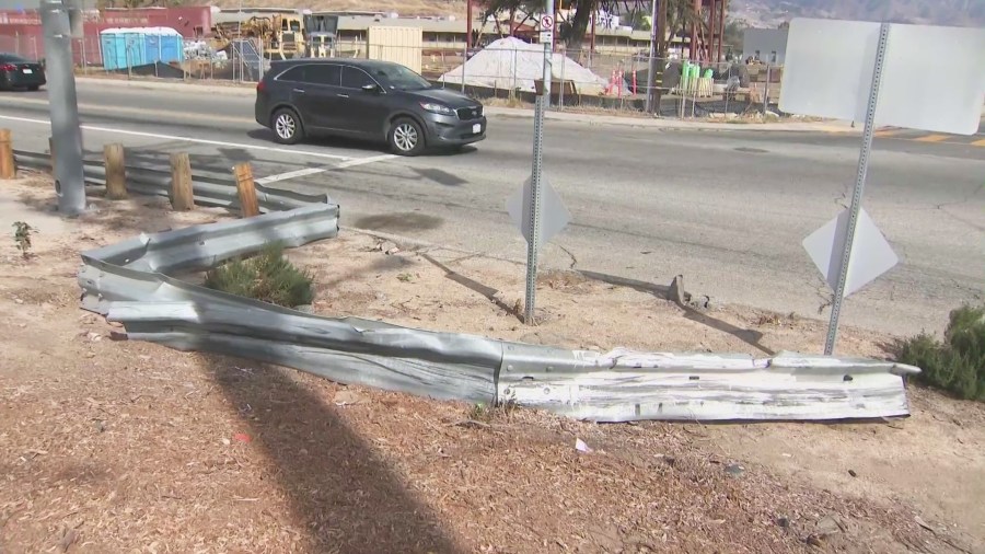 A crushed guardrail near a flood control channel at North Perris Hill Park Road and East Pacific Avenue in San Bernardino where the victims were killed. (KTLA)