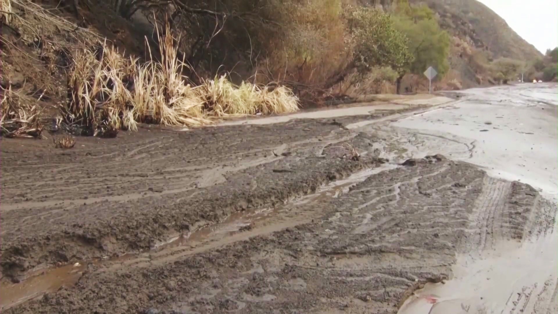 A flooded road as L.A. burn scar areas prepare for threats of mudslides, rockslides and debris runoff ahead of an incoming storm in Southern Calfornia. (KTLA)