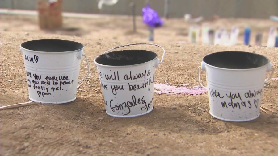 Loved ones created a makeshift memorial to honor Asia Guercy near the flood channel where she and Charles Dark, 31, were killed. (KTLA)