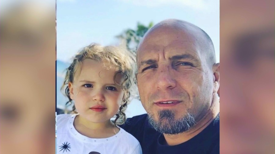 The victim, Josh Nichols, 44, and his child, is seen in a family photo.