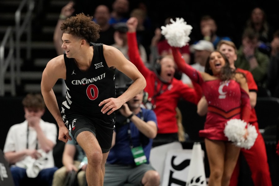 Cincinnati's Dan Skillings Jr. smiles after scoring during the second half of an NCAA college basketball game against Oklahoma State in the first round of the Big 12 Conference tournament, Tuesday, March 11, 2025, in Kansas City, Mo. (AP Photo/Charlie Riedel)