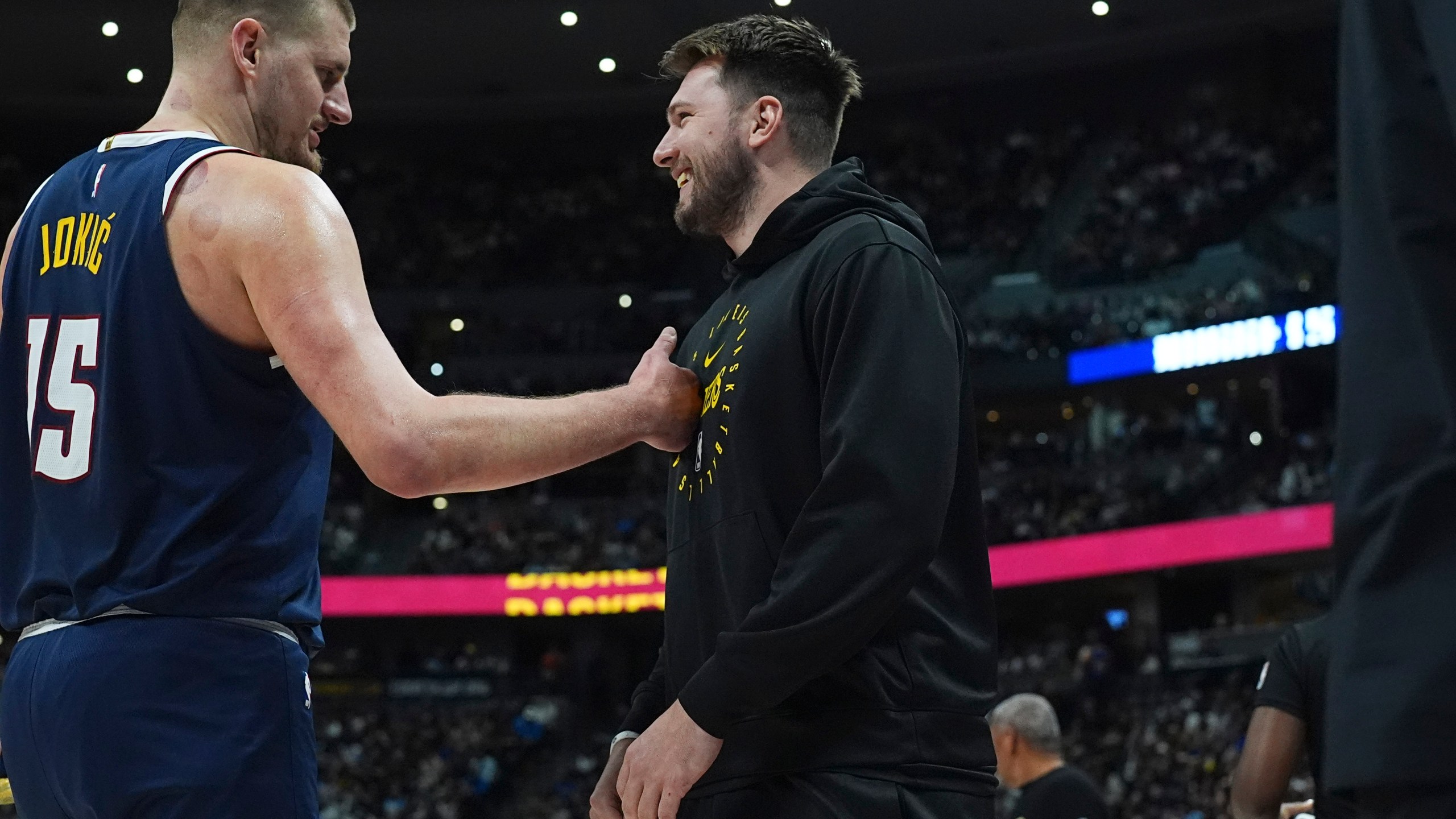 Denver Nuggets center Nikola Jokic, left, greets Los Angeles Lakers guard Luka Doncic, right, in the first half of an NBA basketball game Friday, March 14, 2025, in Denver. (AP Photo/David Zalubowski)