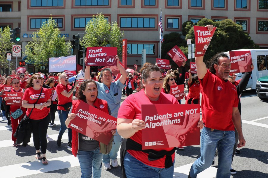 In this photo provided by National Nurses United, nurses hold a rally in San Francisco on April 22, 2024, to highlight safety concerns about using artificial intelligence in health care. (National Nurses United via AP)