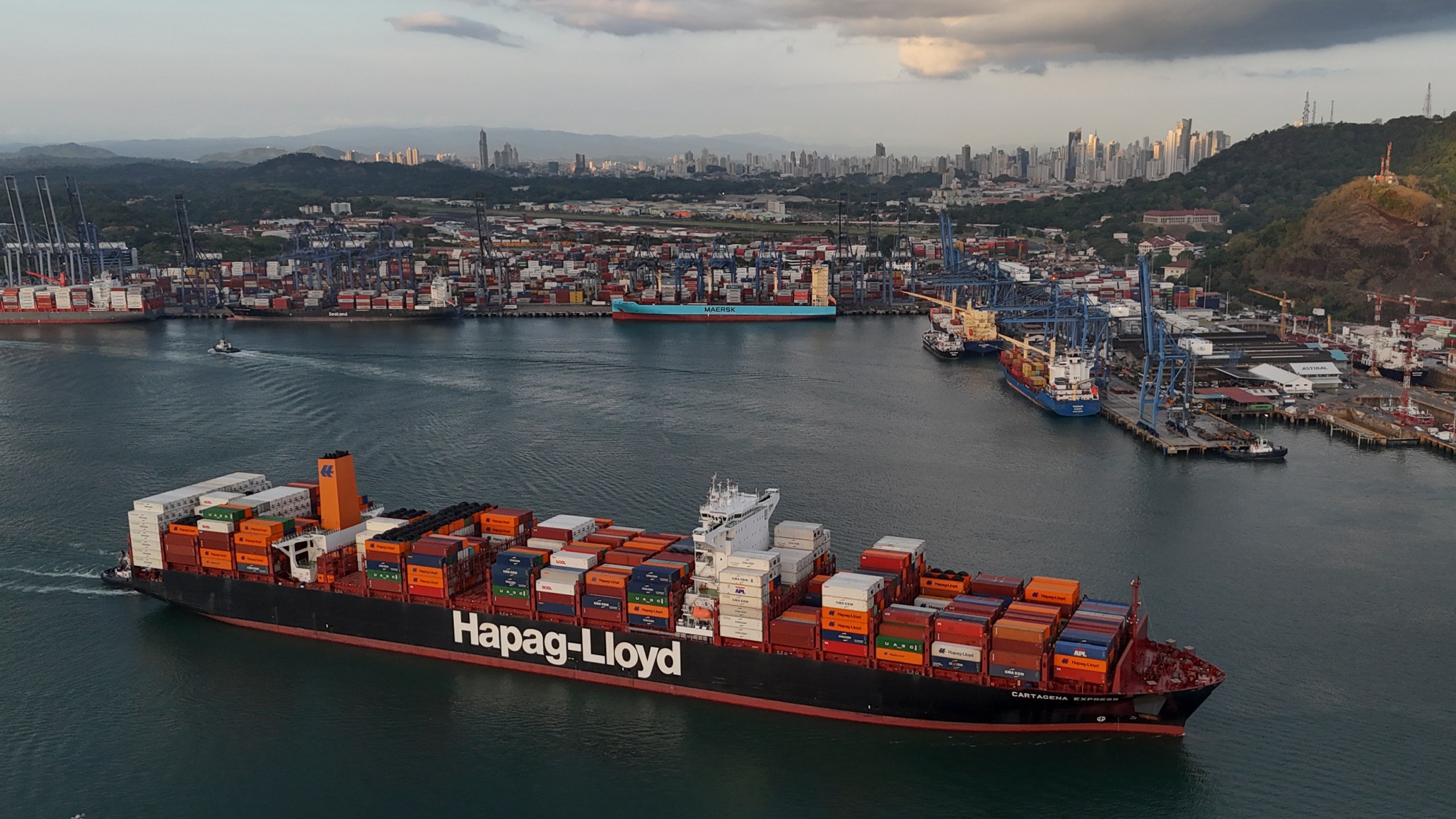 A cargo ship sails past the Panama Canal's Port of Balboa, managed by CK Hutchison Holdings, in Panama City, Thursday, March 13, 2025. (AP Photo/Matias Delacroix)