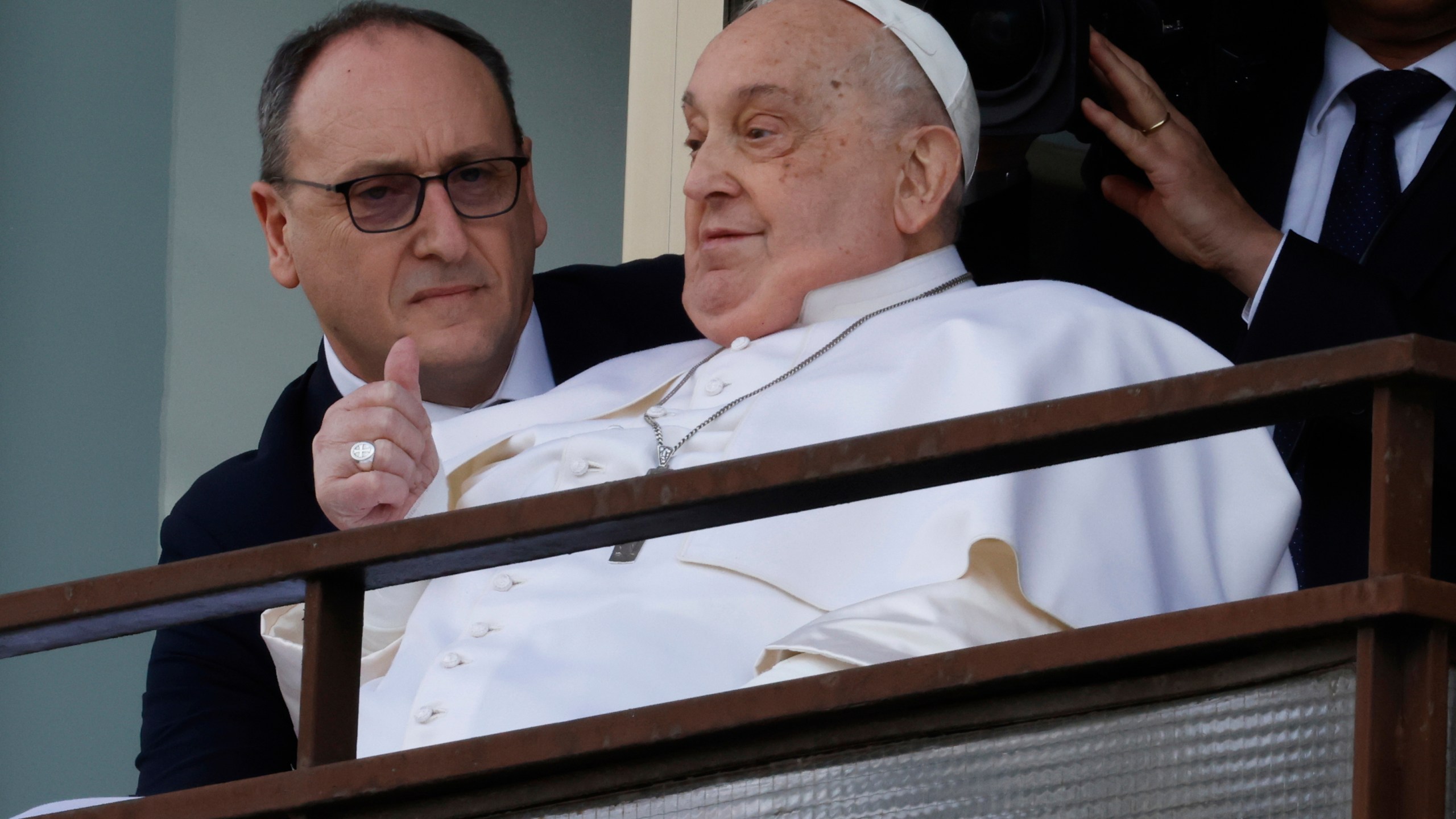 Pope Francis appears at a window of the Agostino Gemelli Polyclinic in Rome, Sunday, March 23, 2025, where he has been treated for bronchitis and bilateral pneumonia since Feb. 14. (AP Photo/Riccardo De Luca)