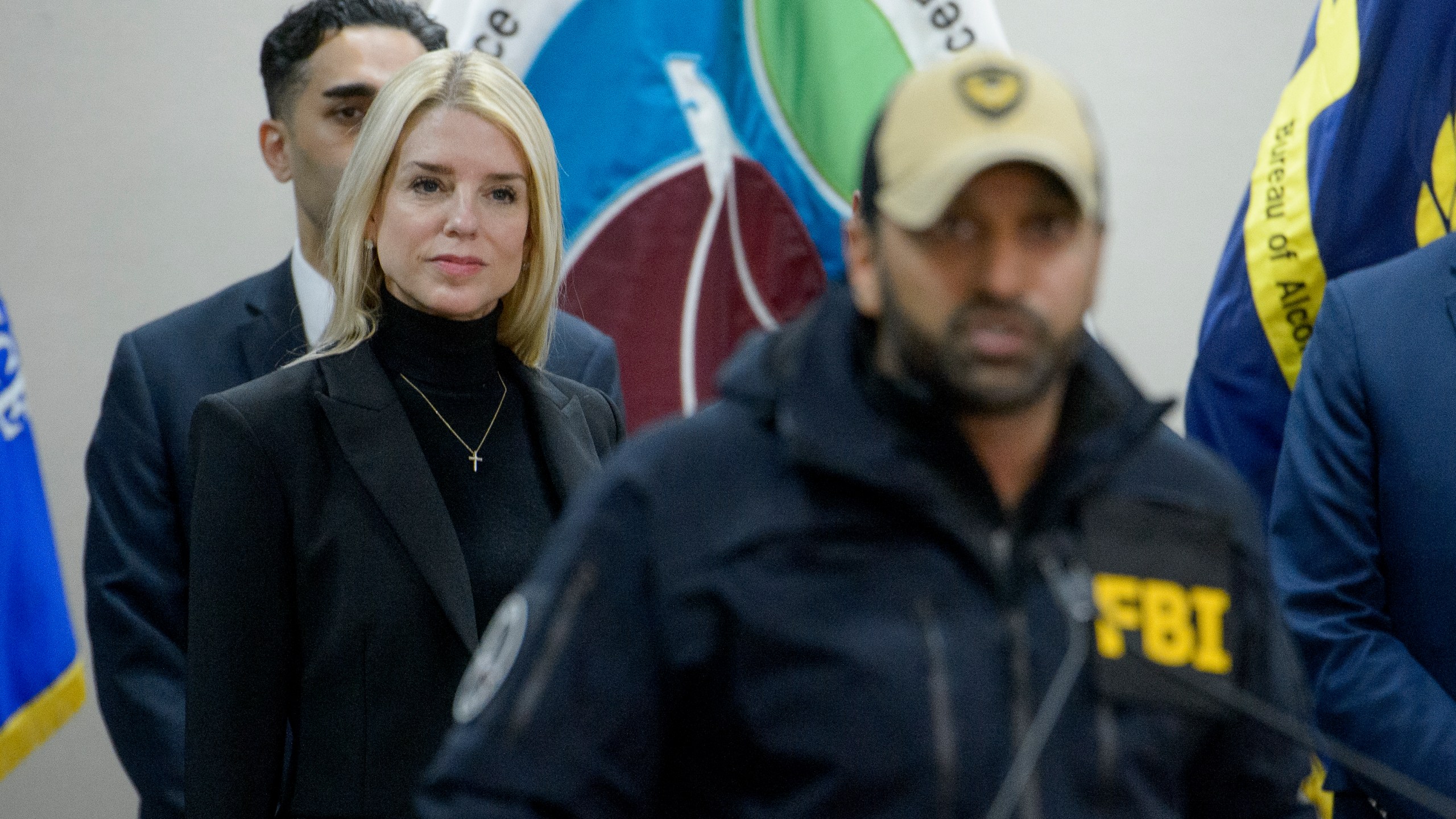 Attorney General Pam Bondi, left, listens as FBI Director Kash Patel speaks about a 24 year-old MS-13 gang leader who was arrested in an operation by the Virginia Homeland Security Task Force in Dale City, VA., on March 27, 2025, during a news conference at the Manassas FBI Field Office, Thursday, March 27, 2025, in Manassas, VA. (AP Photo/Rod Lamkey)