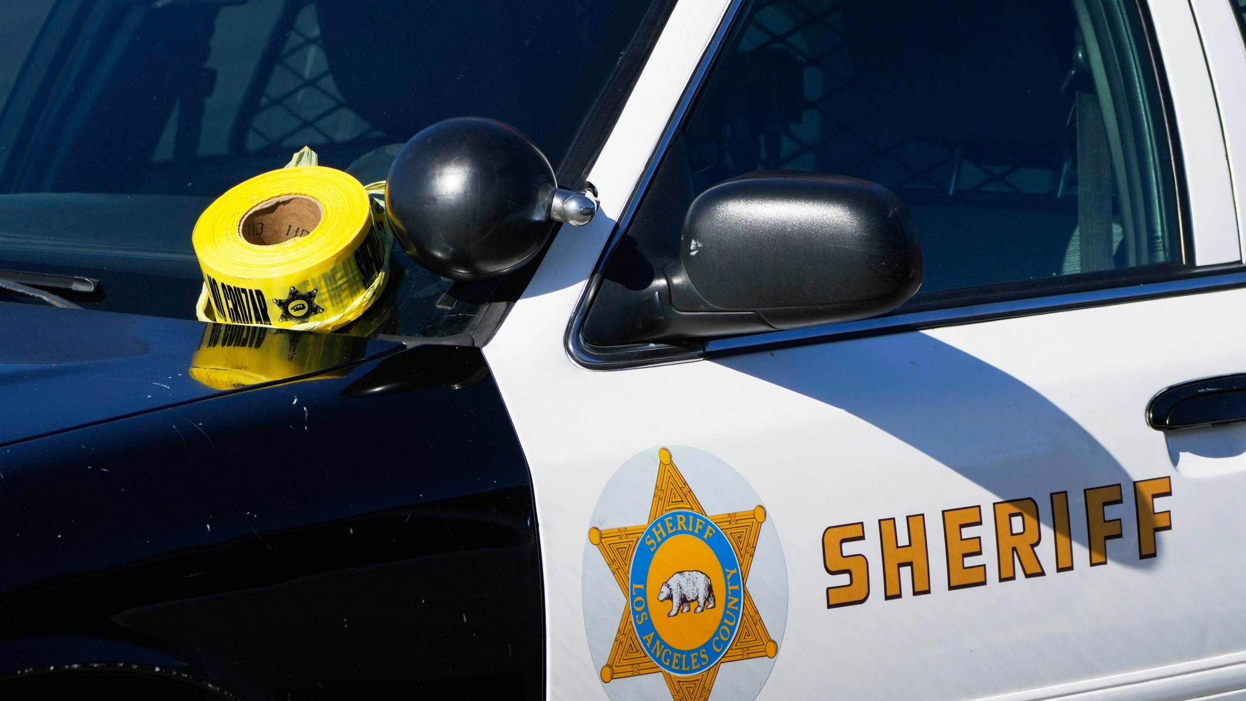FILE - A roll of police tape is left on the windshield of Los Angeles County sheriff's vehicle in the parking lot of its training academy in Whittier, Calif., Wednesday, Nov. 16, 2022. (AP Photo/Jae C. Hong, File)