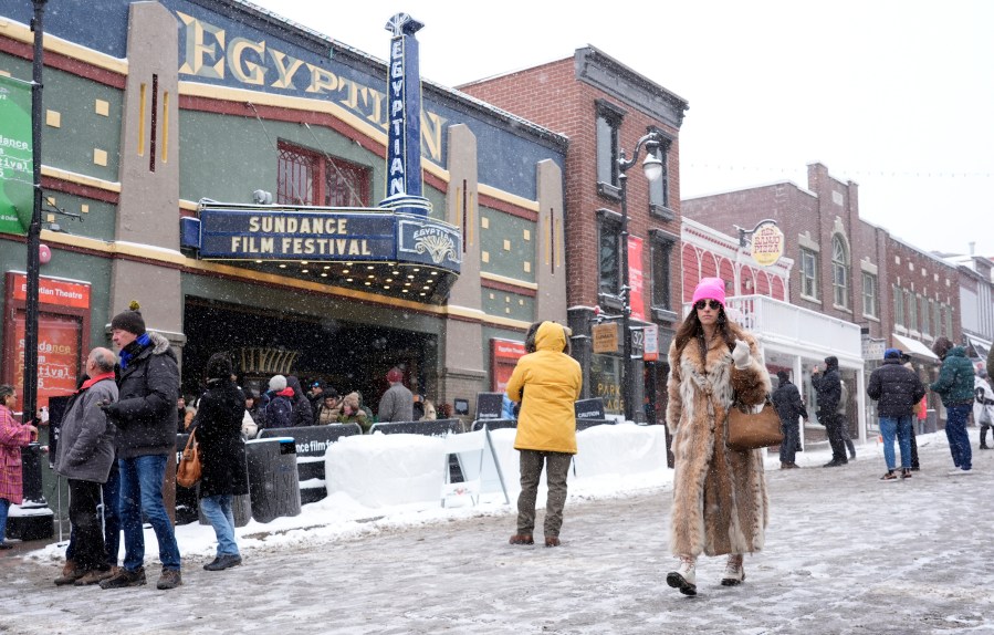 FILE - A Sundance festivalgoer walks past the Egyptian Theatre during the Sundance Film Festival on Jan. 25, 2025, in Park City, Utah. (AP Photo/Chris Pizzello, File)