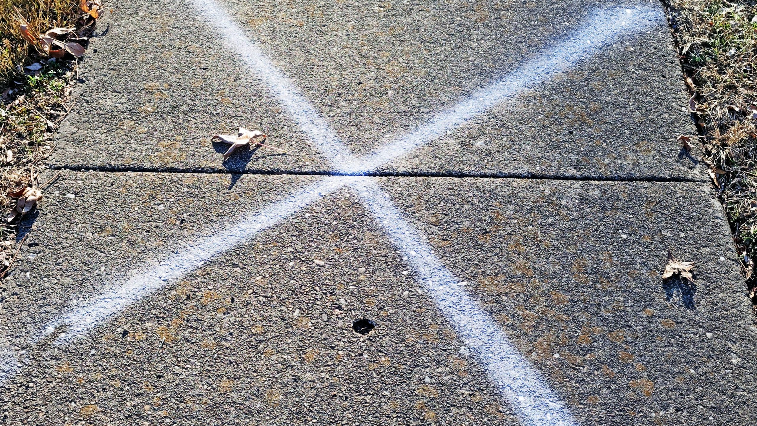 X marked in chalk on a neighborhood sidewalk. (Getty Images)