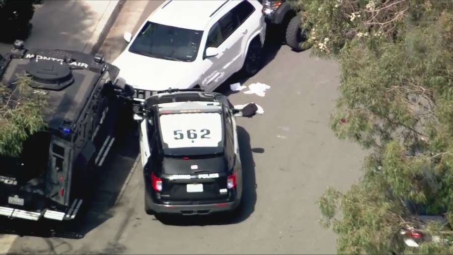 Law enforcement surrounded a white Jeep SUV following a pursuit that ended in Montclair on March 10, 2025. (KTLA)