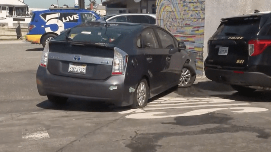 A gray Prius involved in a law enforcement pursuit is shown where it came to a stop after authorities deployed spike strips Friday morning, March 21, 2025. (KTLA)