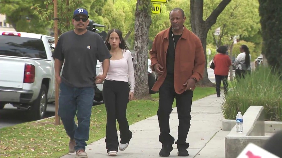From left: Ricardo Hurtado, his daughter Noemi Hurtado, and community activist Najee Ali, hold a press conference outside Blair Middle School in Pasadena on March 28, 2025. (KTLA)