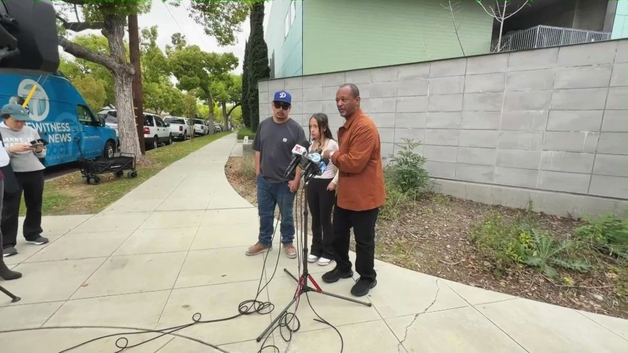 Ricardo and Noemi Hurtado along with community activist Najee Ali, hold a press conference outside Blair Middle School in Pasadena on March 28, 2025. (KTLA)