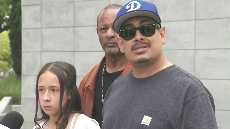 Ricardo and Noemi Hurtado along with community activist Najee Ali, hold a press conference outside Blair Middle School in Pasadena on March 28, 2025. (KTLA)