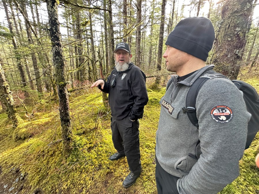 Mike Mazouch, left, animal control and protection director for Juneau Animal Rescue, and Thom Young-Bayer, an animal control officer, speak about a recent sighting of the dog known as Jackie on Thursday, March 27, 2025, in Juneau, Alaska. (AP Photo/Becky Bohrer)