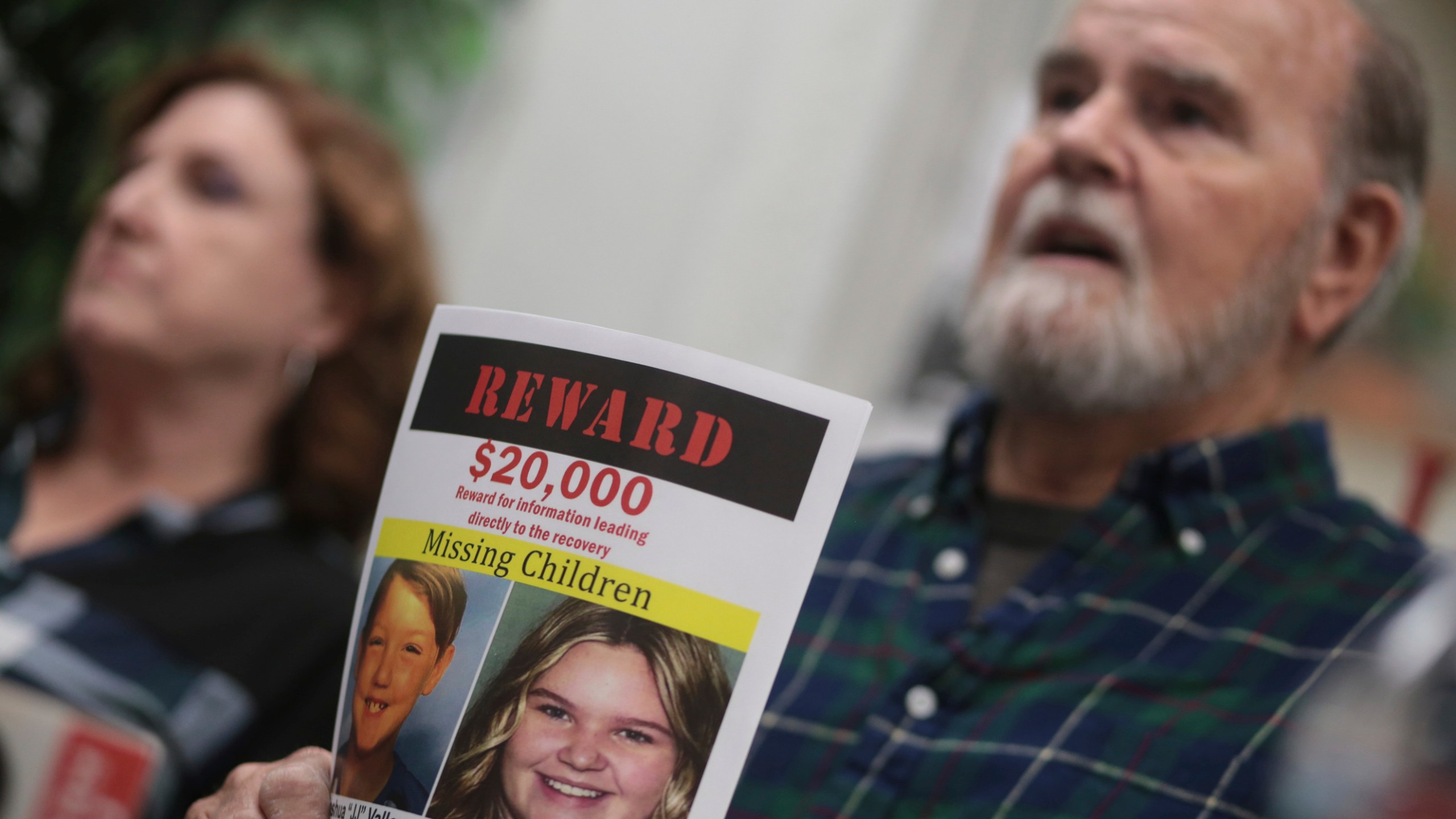 FILE - Larry Woodcock speaks to media members at the Rexburg Standard Journal Newspaper in Rexburg, Idaho on Jan. 7, 2020, while holding a reward flyer for Joshua Vallow and Tylee Ryan. (John Roark/The Idaho Post-Register via AP, File)